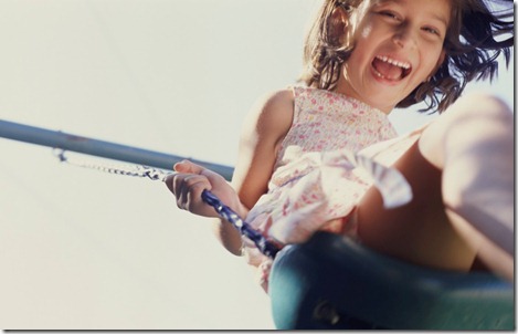 Happy Girl on Swing --- Image by © Royalty-Free/Corbis